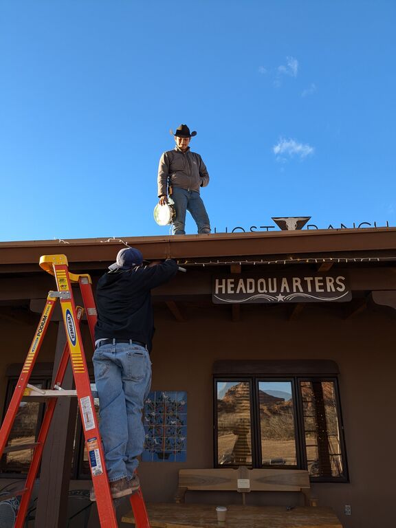 Facilities staff hanging lights at Headquarters