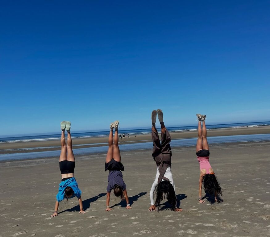 Head stands on the beach along the Olympic Coast with Camp Thunderbird for Girls