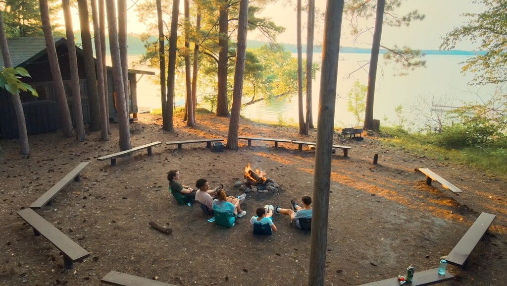 Hanging around the fire at Camp Thunderbird for Boys
